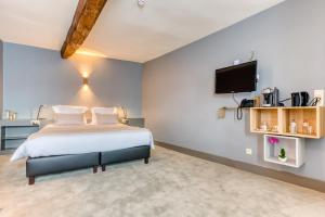 Postel nebo postele na pokoji v ubytování Hôtel Imperi'Ale