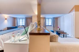 Postel nebo postele na pokoji v ubytování Hôtel Imperi'Ale