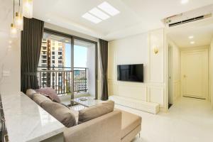 a living room with a couch and a television at Saigon Banhada - Rivergate - Infinity Pool in Ho Chi Minh City