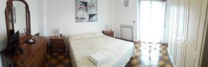 a bedroom with a bed and a dresser and a mirror at Locanda dei miracoli in Pizzoli