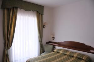Voodi või voodid majutusasutuse Hotel Biancamaria toas