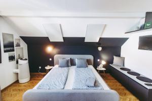 a bedroom with a large bed with blue pillows at Lackenbauer in Muggenau