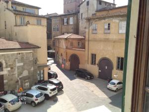 a view of a city street with cars parked at tita's house in Lucca