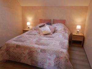 a bedroom with a large bed with two night stands at Rêve Chablisien in Chablis