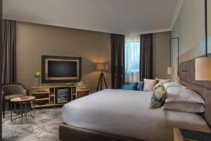 a hotel room with a large bed and a television at Expo Hotel Sofia - Free Airport Shuttle in Sofia +52 photos