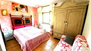 a bedroom with a bed and a couch in it at Bed & Breakfast Il Rosmarino in Bosa +49 photos