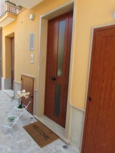 - une entrée pour un bâtiment avec une porte en bois dans l'établissement Antico Vicolo, à Scilla