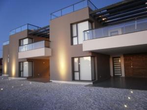 a large house with a lot of windows at El Terrado I in Las Grutas