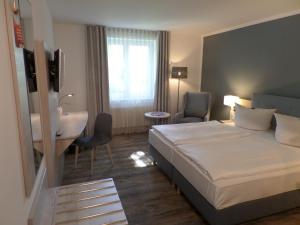 Postel nebo postele na pokoji v ubytování C-YOU Hotel Chemnitz