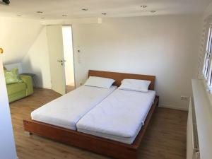 a bedroom with a large bed with two pillows at Wendlers Ferienwohnungen #7 in Schwaig bei Nürnberg