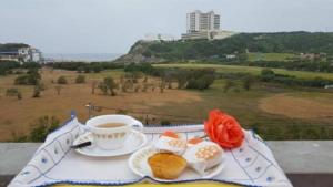 a tray of food and a cup of coffee on a table at Entre o Mar e a Serra in Maceira