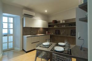 a kitchen with a table and chairs in a room at Palazzo RICCA GUARDUCCI 2 in Montefiascone