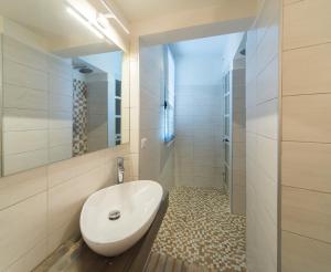 a bathroom with a white sink and a mirror at Palazzo RICCA GUARDUCCI 2 in Montefiascone +8 photos
