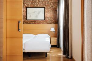 A bed or beds in a room at Wello Apartments