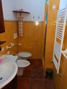 a bathroom with a white toilet and a sink at Contrada Vigna in Vietri sul Mare