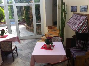 a room with two tables and chairs and a patio at Pension Seba in Grevesmühlen