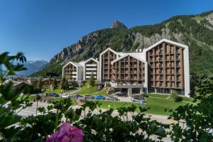 a view of a hotel with mountains in the background at TH Courmayeur in Courmayeur