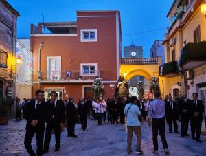 a group of men in suits walking down a street at B&B San Trifone in Adelfia