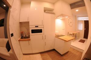a small kitchen with a refrigerator and a sink at APARTAMENTOs URDAIBAI 2 in Bermeo