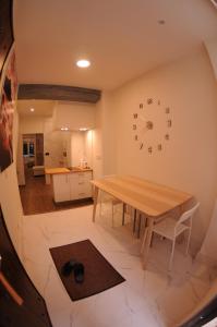 a dining room with a table and a clock on the wall at APARTAMENTOs URDAIBAI 2 in Bermeo