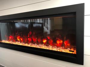 a fireplace is shown with flames in it at Blue Mountain 2 Story Studio Loft in Blue Mountains
