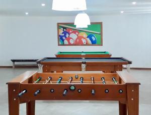 a foosball table in a room with a painting at Apartamento Le Bon Vivant Arraial do Cabo in Arraial do Cabo