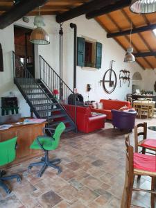 a living room with a red couch and a staircase at Corte Attilea in Valeggio sul Mincio