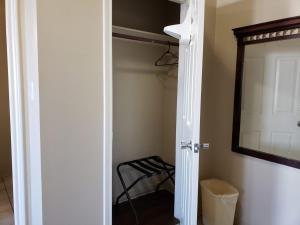 a walk in closet with a mirror and a stool at Crossroads Inn & Suites in Victoria +20 photos