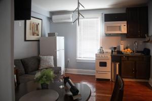 a kitchen and a living room with a white refrigerator at Vacation House DC in Washington
