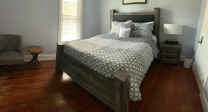 a bedroom with a large bed and a chair at Vacation House DC in Washington