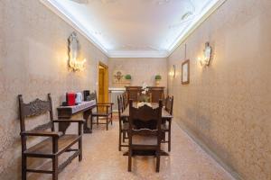 a dining room with chairs and a table in a room at Hotel Mezzo Pozzo in Venice