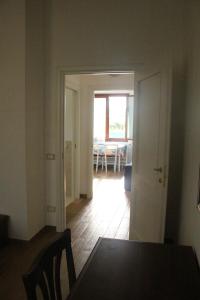 a dining room with a table and a room with a window at Casa Vacanze Al Basyta in Buseto Palizzolo