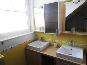a bathroom with two sinks and a mirror at Natasha's Garden House in Dol pri Ljubljani