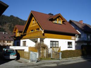 a large house with a wooden roof at Appartementhaus Erasim in Schladming