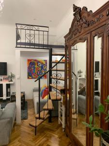 a living room with a spiral staircase in a room at Charming studio apartment in the heart of the Jewish District! in Kraków