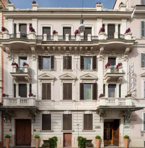 a large white building with windows and balconies at Alpi Hotel in Rome