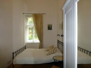 a bedroom with a bed and a window at Apartment Sadova in Karlovy Vary