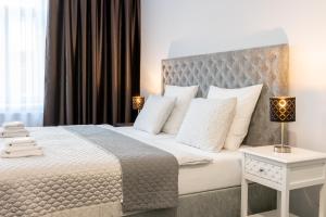 Postel nebo postele na pokoji v ubytování Penzion Apartmány Hradební