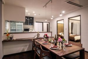 a dining room and kitchen with a table and chairs at Ginowan - House / Vacation STAY 46771 in Ginowan