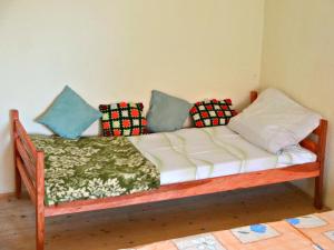 a wooden couch with pillows on it in a room at Dream in Drvar