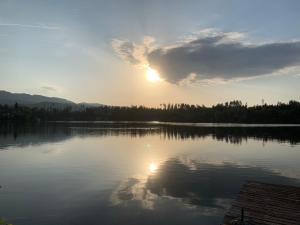 een uitzicht op een meer met zonsondergang bij Seepension Smoley in Villach