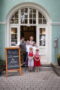 
a family posing for a picture in front of a building at Riemhofer Alter Schlachthof in Regensburg

