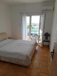 Postel nebo postele na pokoji v ubytování Apartmani Paula