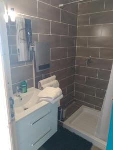 a bathroom with a sink and a bath tub at le Mas du lac - spa et détente in Monestier-dʼAmbel