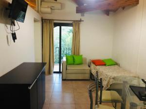 a living room with a couch and a table at Apart-Hotel Gibert's House in Villa Carlos Paz