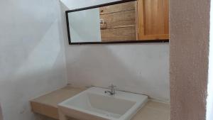 a bathroom with a sink and a mirror at Cabanas chaac calakmul in Xpujil