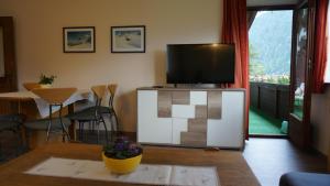 a living room with a television on top of a table at St. Hubertus in Pettneu am Arlberg