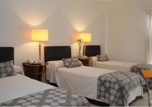 מיטה או מיטות בחדר ב-Parra Hotel & Suites