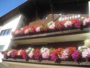 a bunch of flowers on the side of a building at St. Hubertus in Pettneu am Arlberg