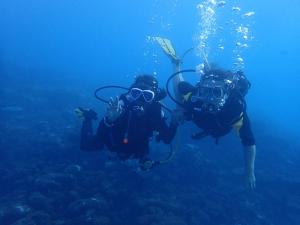 two people are diving in the ocean at Xen Midu Hotel Addu City Maldives in Midu
